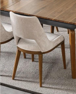 A laconic, modern chair with high wooden legs and upholstery in a pleasant, light cream color for the dining room