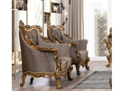 A luxurious Classic r wing chair in dark gray with a golden baroque design from Chesterfield